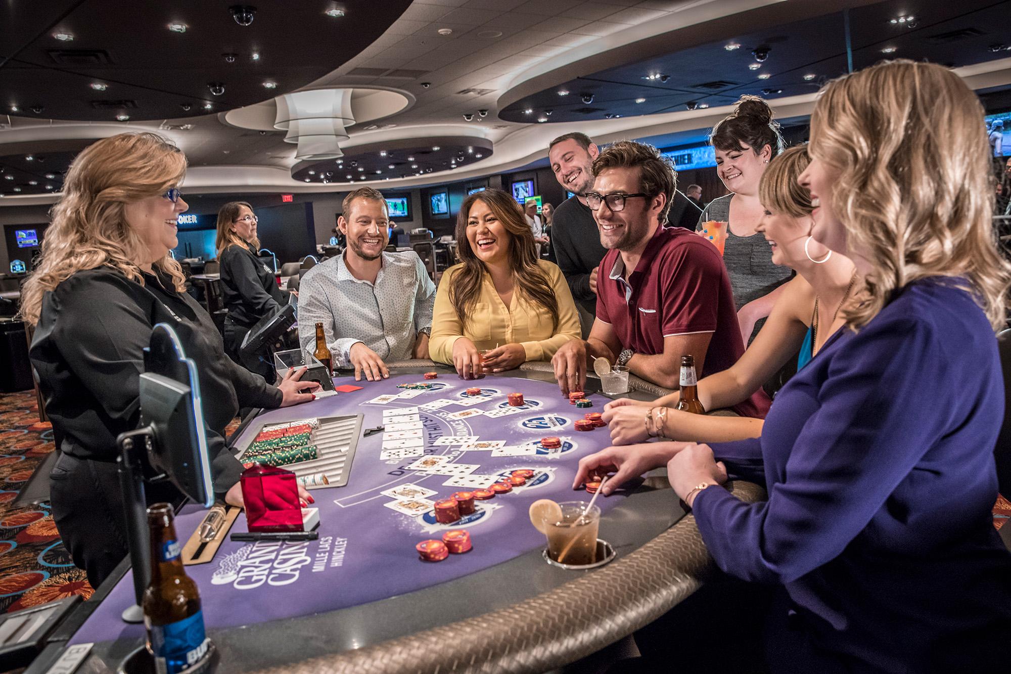 Group of people playing poker at Grand Casino